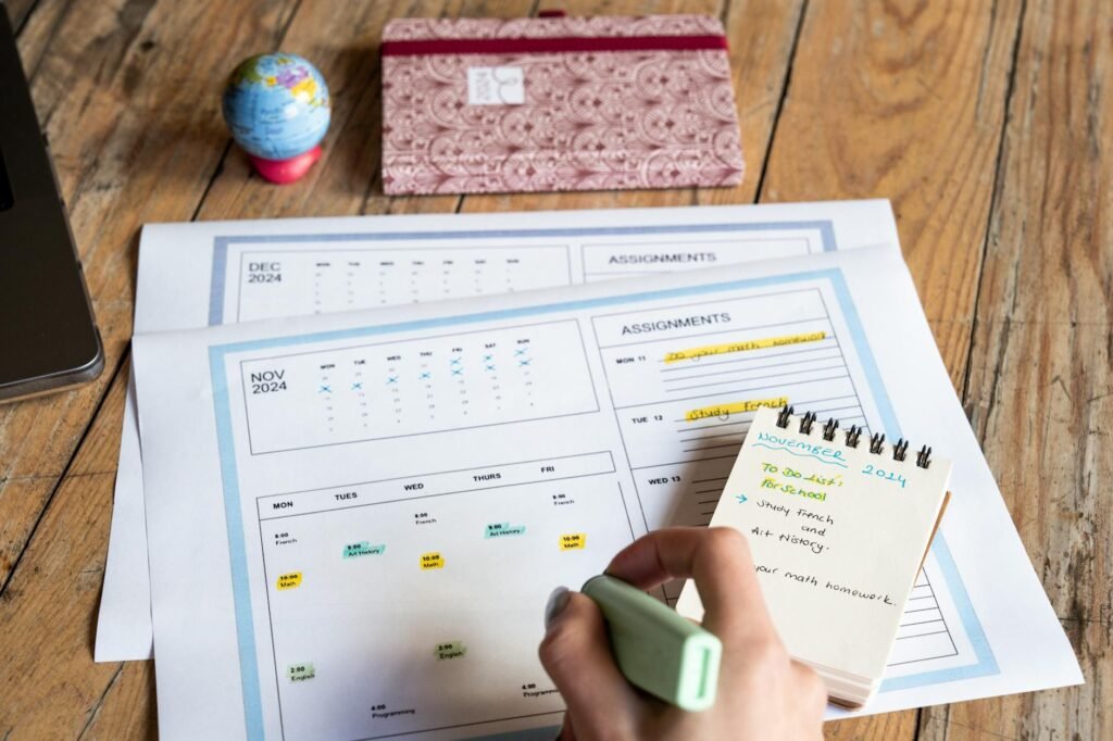 Hand writing bill due dates on a paper calendar