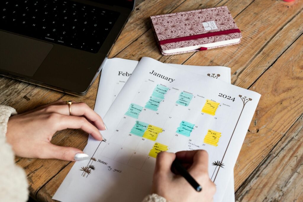 Calendar and financial worksheet on a desk for planning money goals