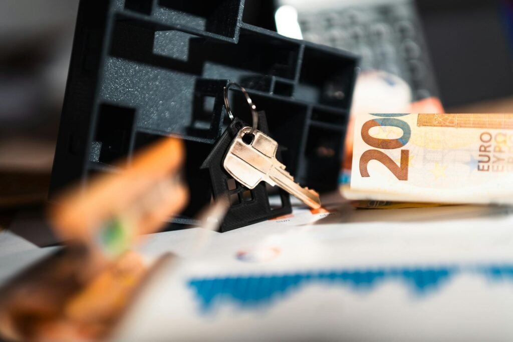 Apartment keys resting on a lease next to a budget worksheet