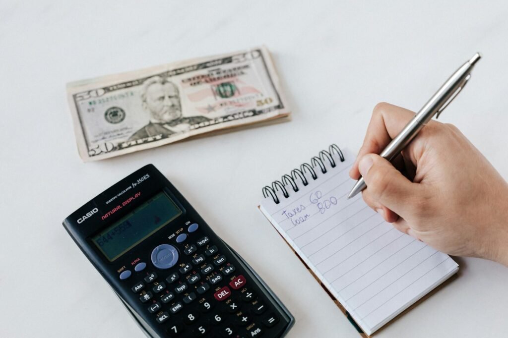 Notebook and bills on a desk for a simple budgeting session