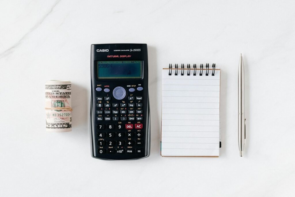 A budgeting notebook and calculator on a clean desk