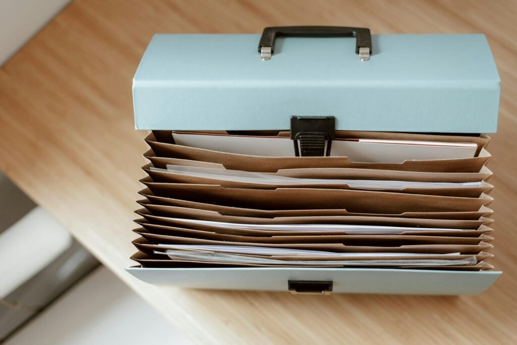 A folder holding organized financial paperwork