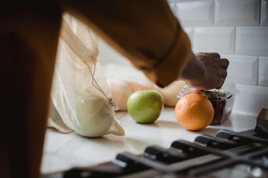 Hands unpacking groceries on a kitchen counter