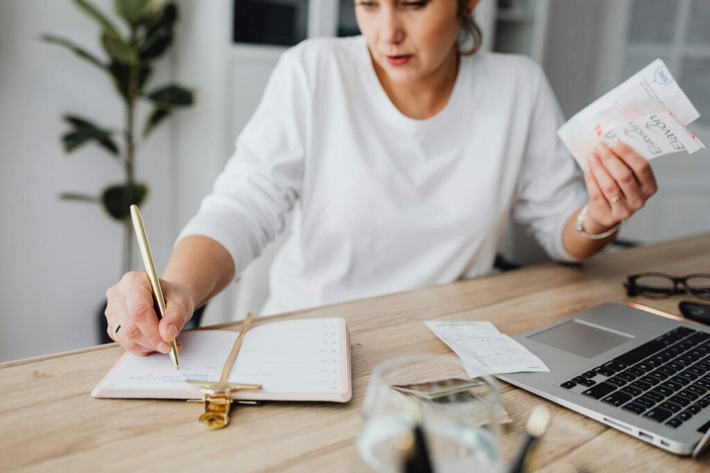 Budgeting notebook and receipts on a tidy desk