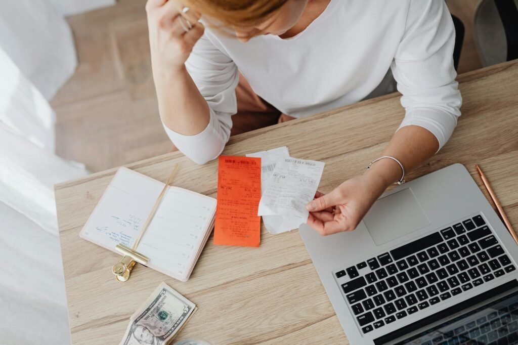 Grocery receipt and handwritten meal plan next to a budgeting notebook