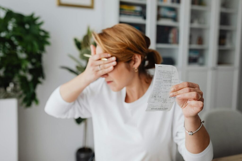 Grocery receipts and a meal-planning list spread out on a kitchen counter.