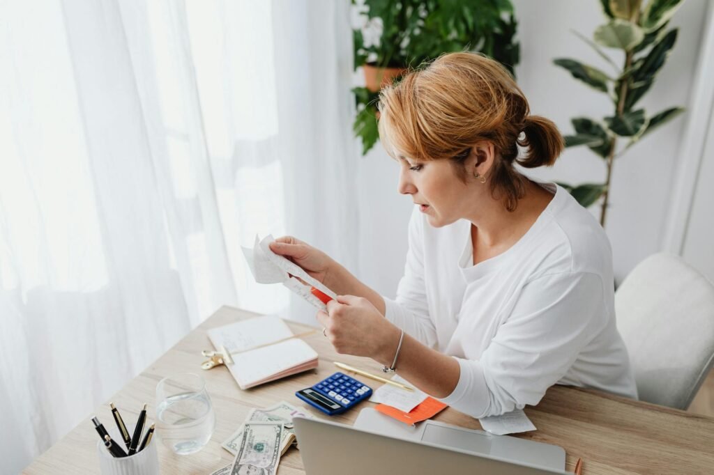 Budgeting notebook and receipts on a desk