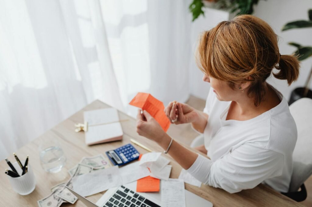 Notebook, calculator, and receipts on a tidy desk for budgeting