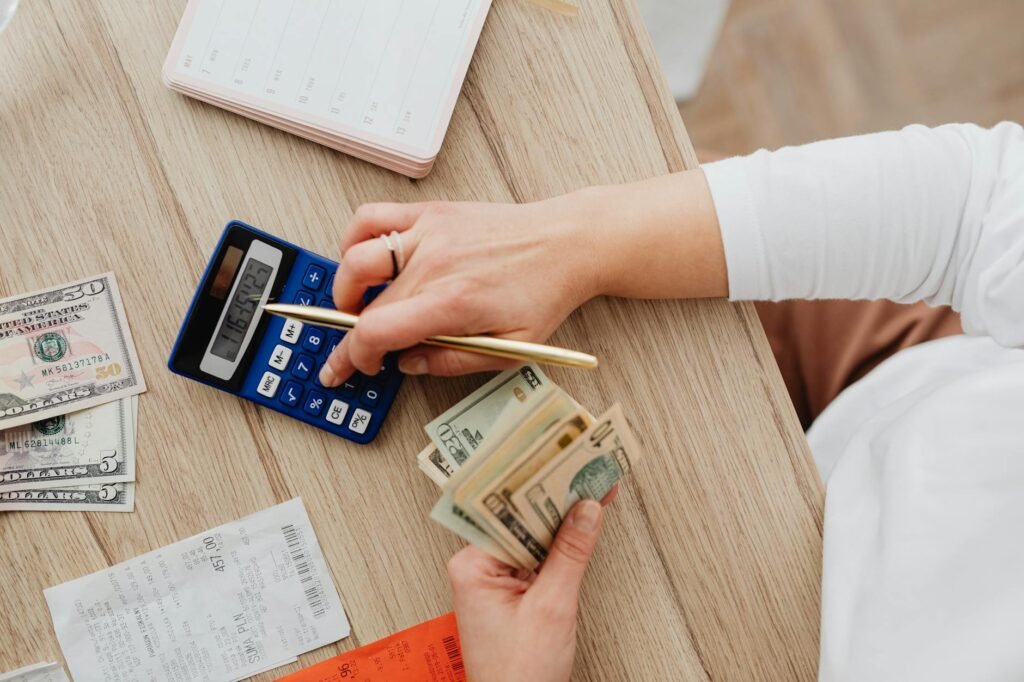 A budgeting notebook and household bills spread across an organized kitchen table
