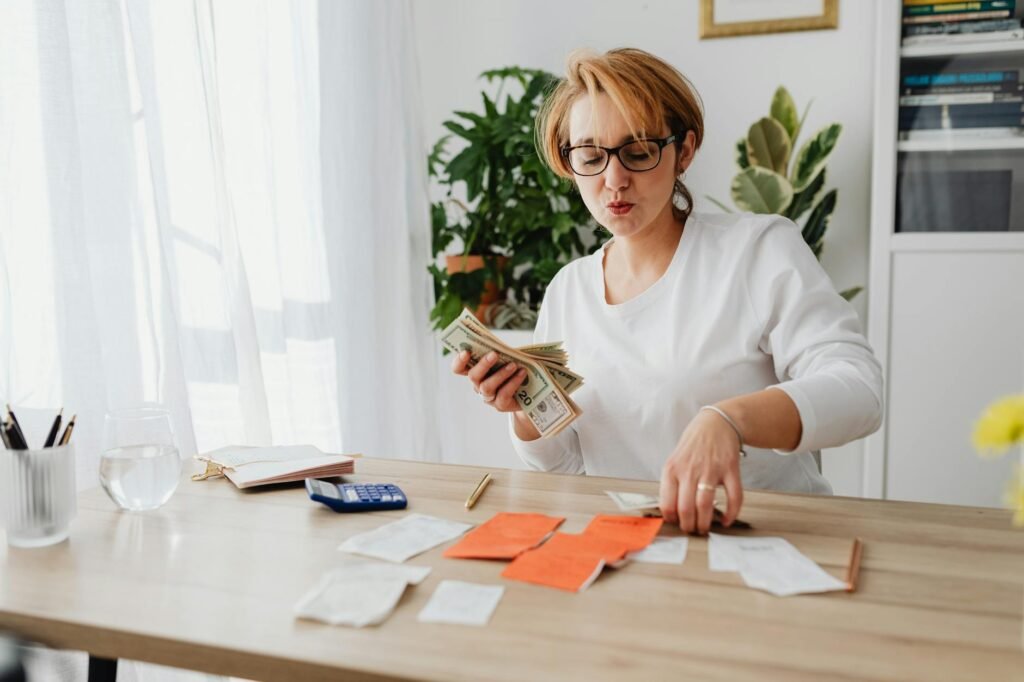 Household bills, calendar, and calculator arranged neatly on a table