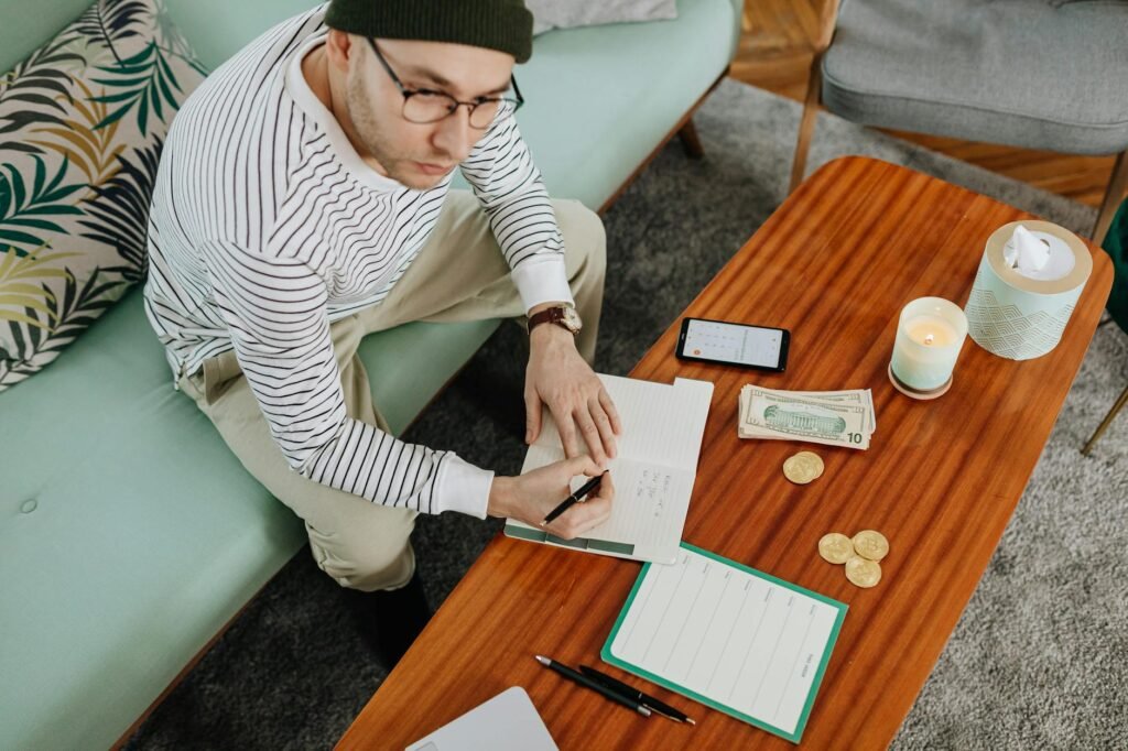 Phone and notebook used to track recurring bills