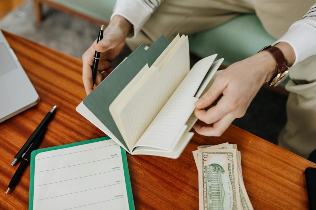 Notebook budget and household bills on a kitchen table