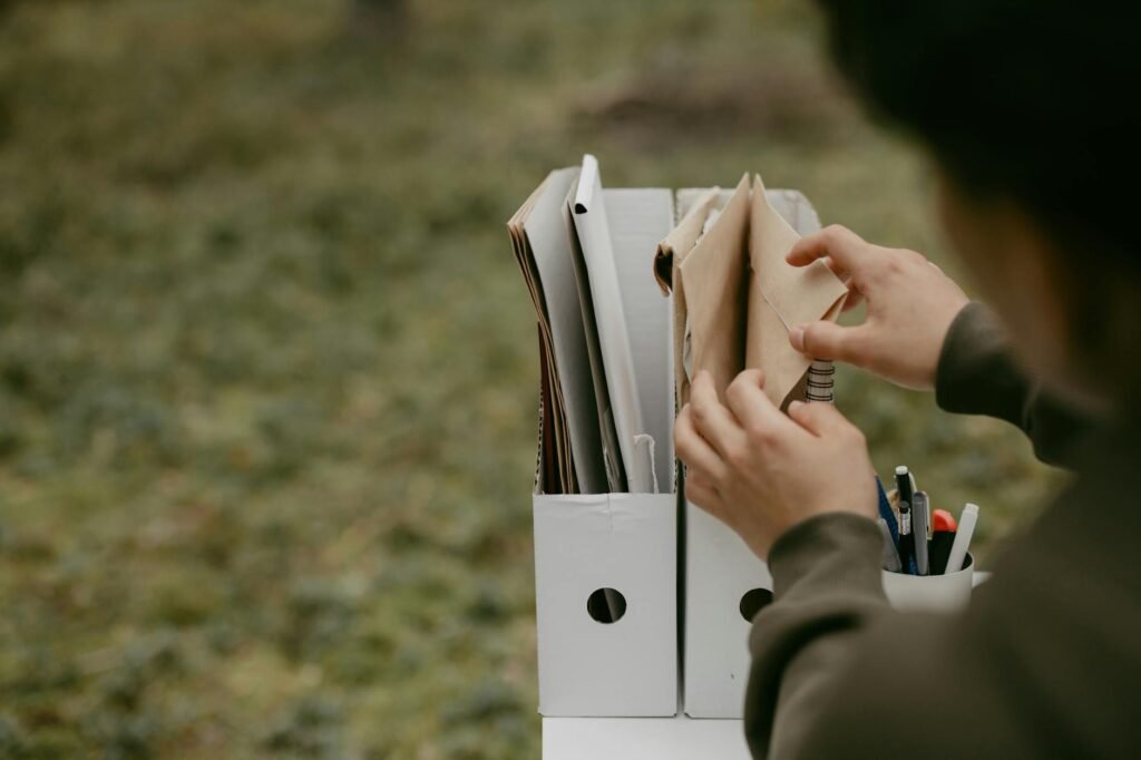 Hands sorting bills and paperwork into folders
