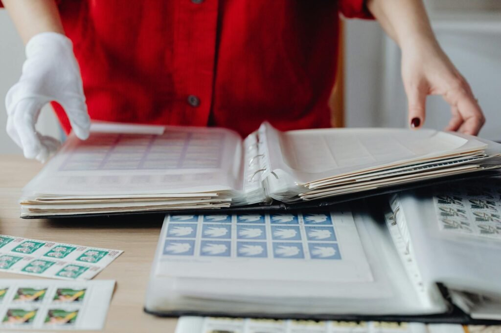 Hands sorting bills and envelopes on a table