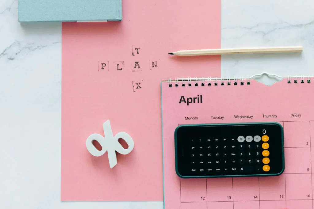 Calendar with bill due dates marked next to a calculator