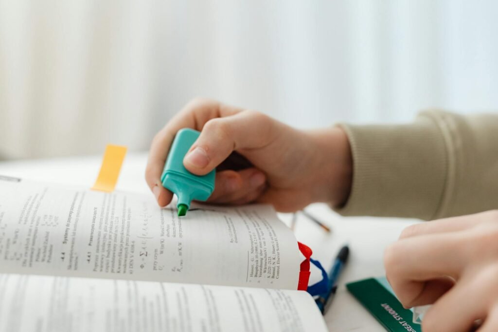 Hands highlighting recurring charges on a bank statement