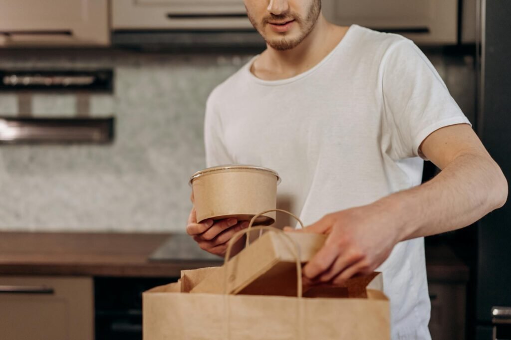 Meal prep containers next to a handwritten grocery list