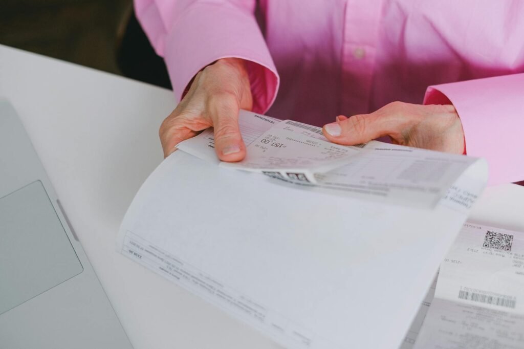 Desk with bank statements and a simple expense tracker worksheet