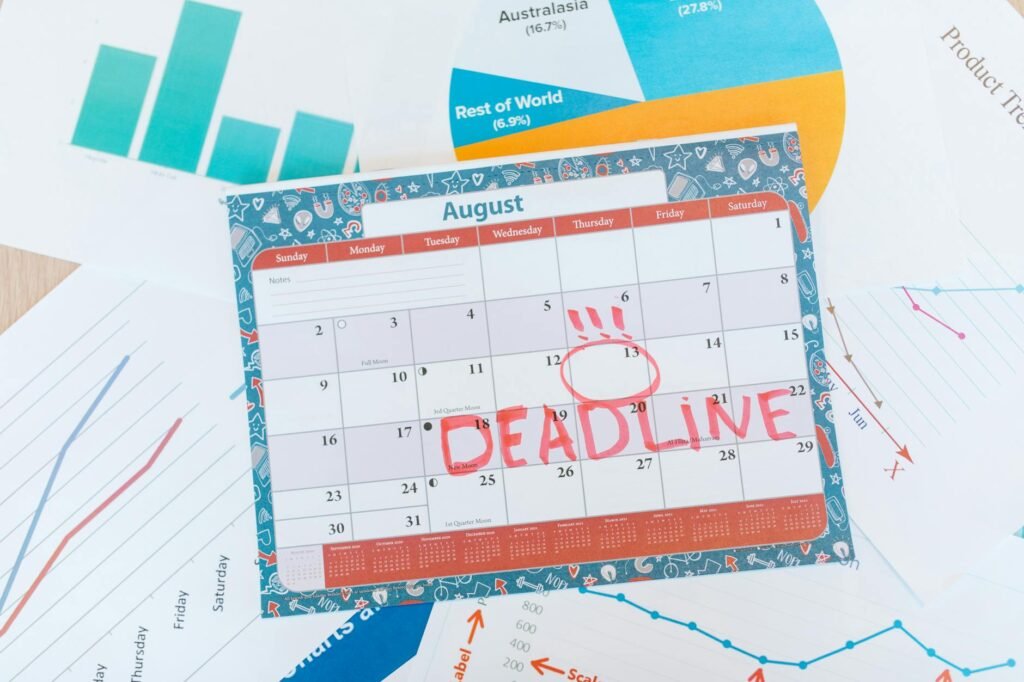 Calendar reminders next to a paper calendar and household bills