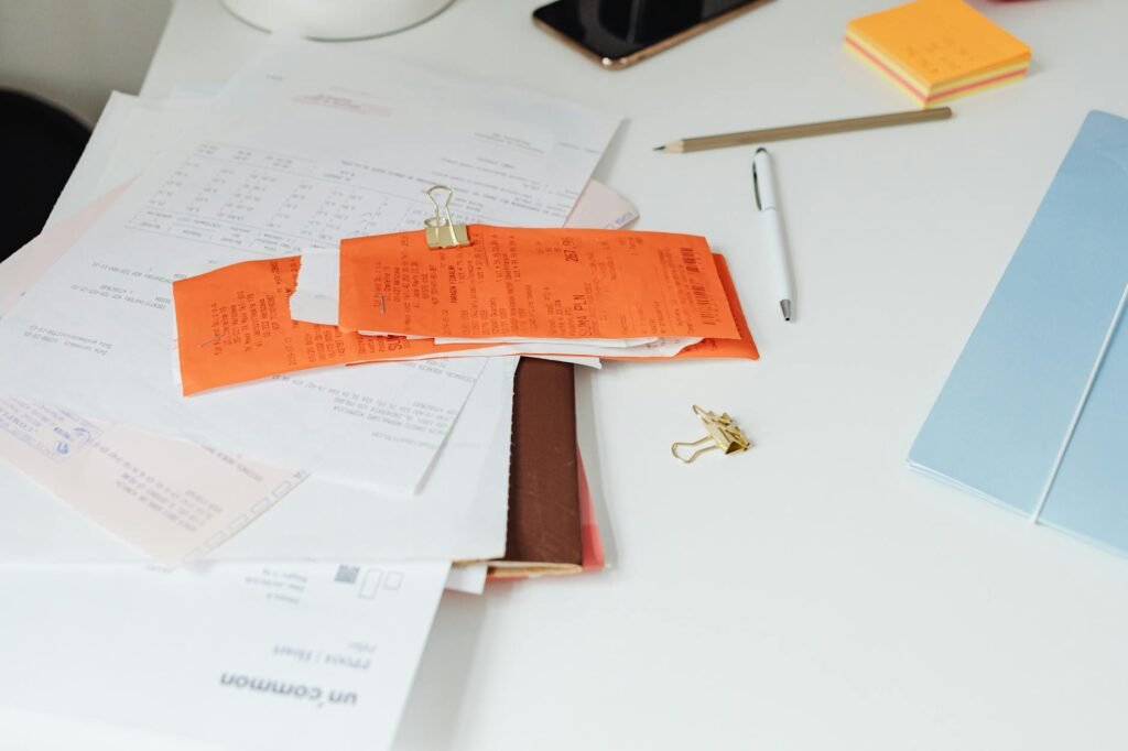 A grocery receipt on a table with a payment card