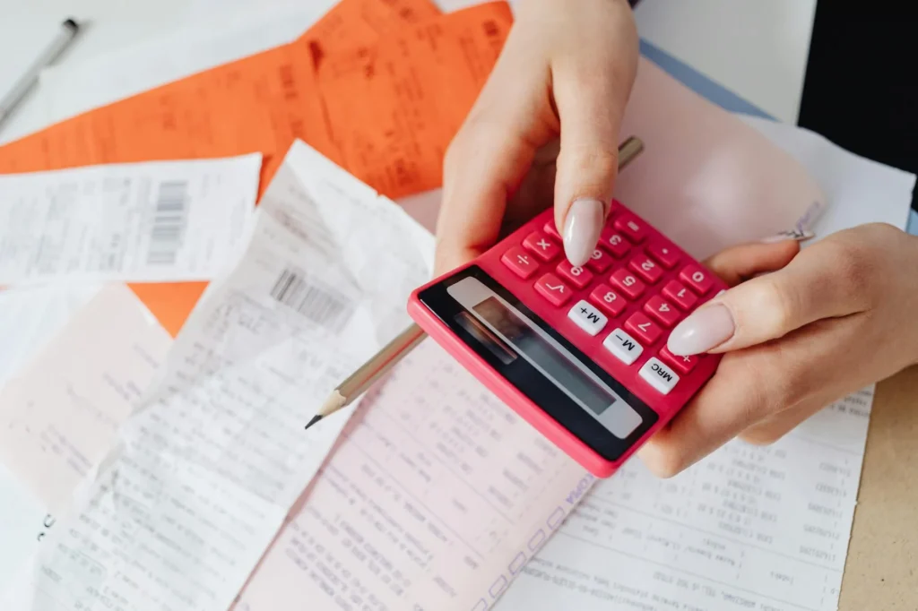 Folders and a calculator used to organize bills and due dates