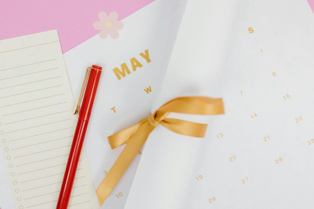 Notebook and calendar on a desk ready for a monthly money reset