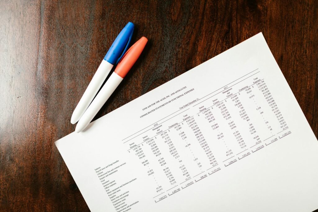 Person reviewing monthly statements at a kitchen table