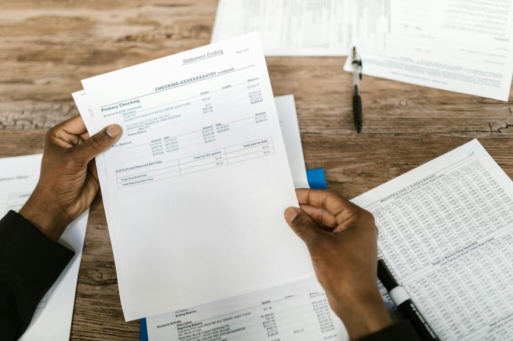 Hands reviewing insurance documents and budget papers