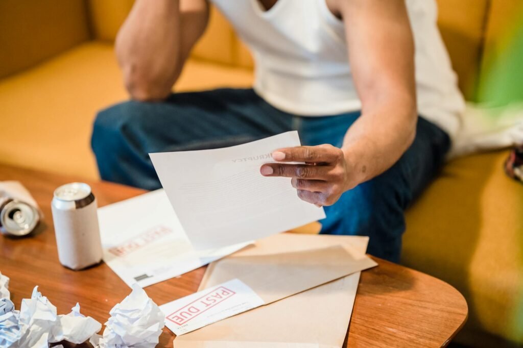Hands sorting household bills for the month