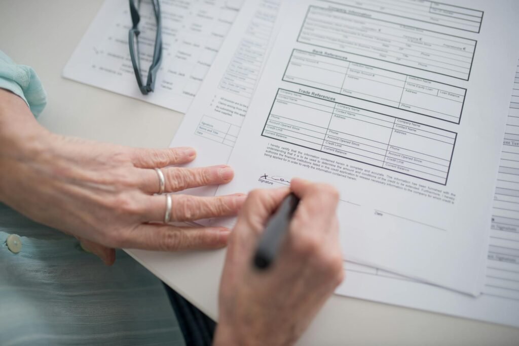 Hands reviewing a bank statement with a pen