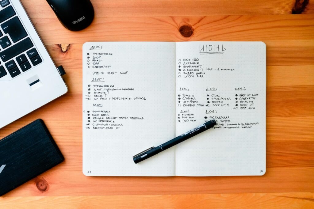 Notebook with a handwritten spending tracker on a desk