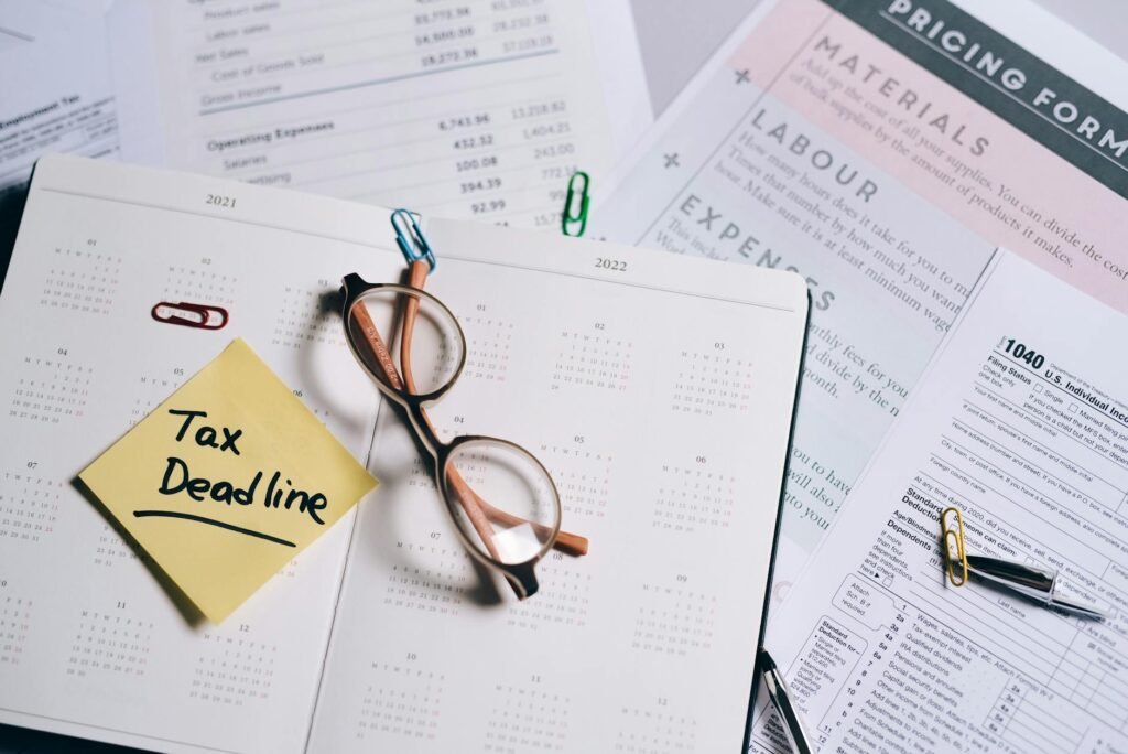 Budget notebook with receipts and a phone showing a calendar reminder