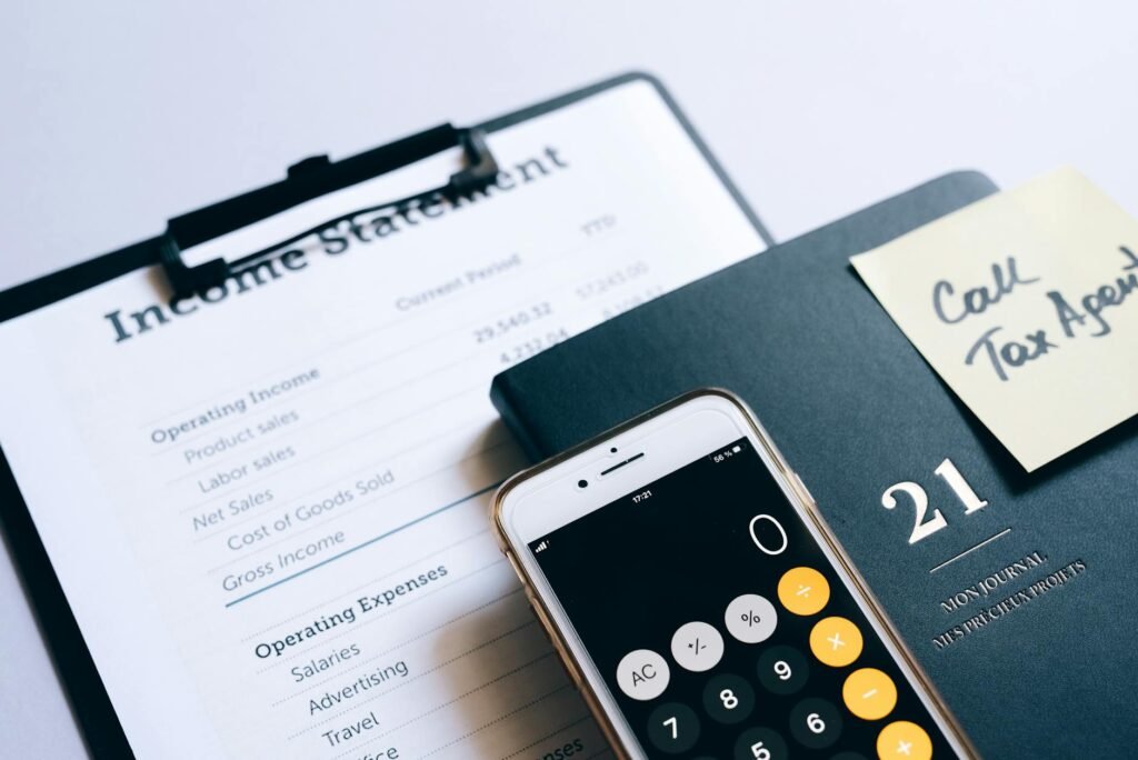 Notepad with call notes next to a phone