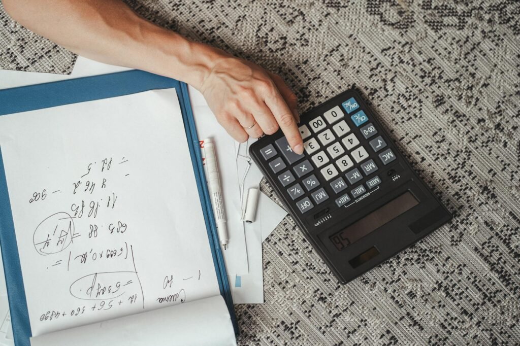Notebook and calculator on a desk for budgeting