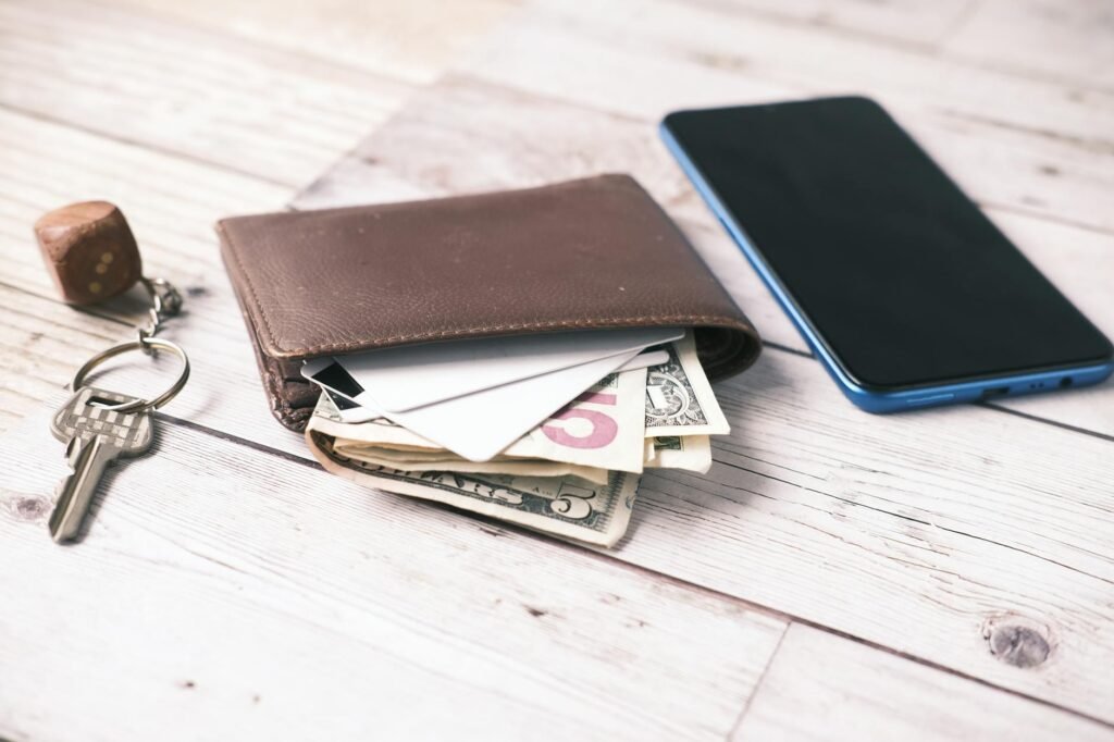 Smartphone beside a notebook used to track almost purchases