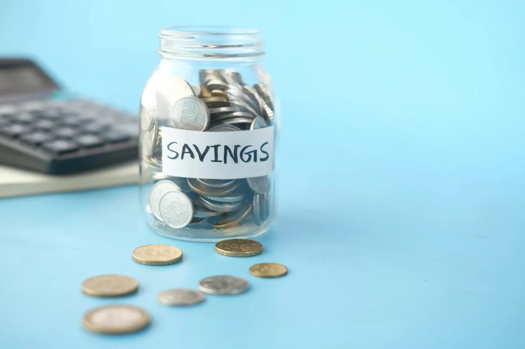 Savings jar next to receipts on a kitchen table