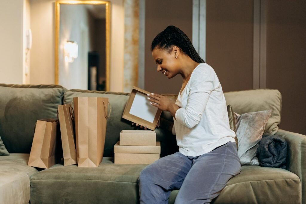 Person looking thoughtfully at an online shopping cart on their phone